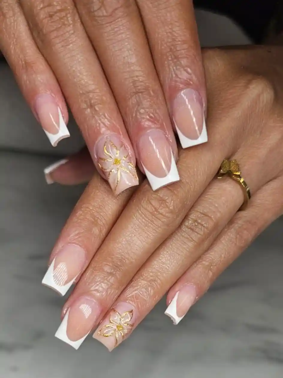White French tips with gold floral accents