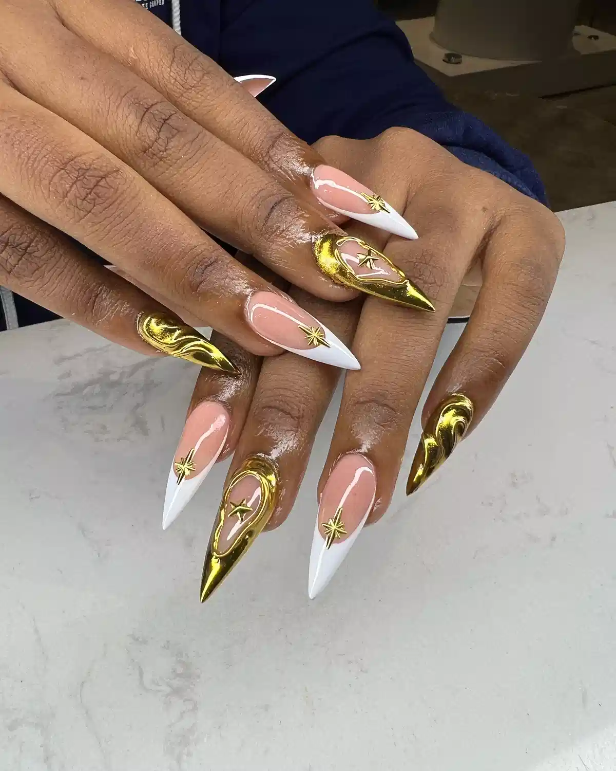 Stiletto Nails with White Tips and Reflective Gold Accents