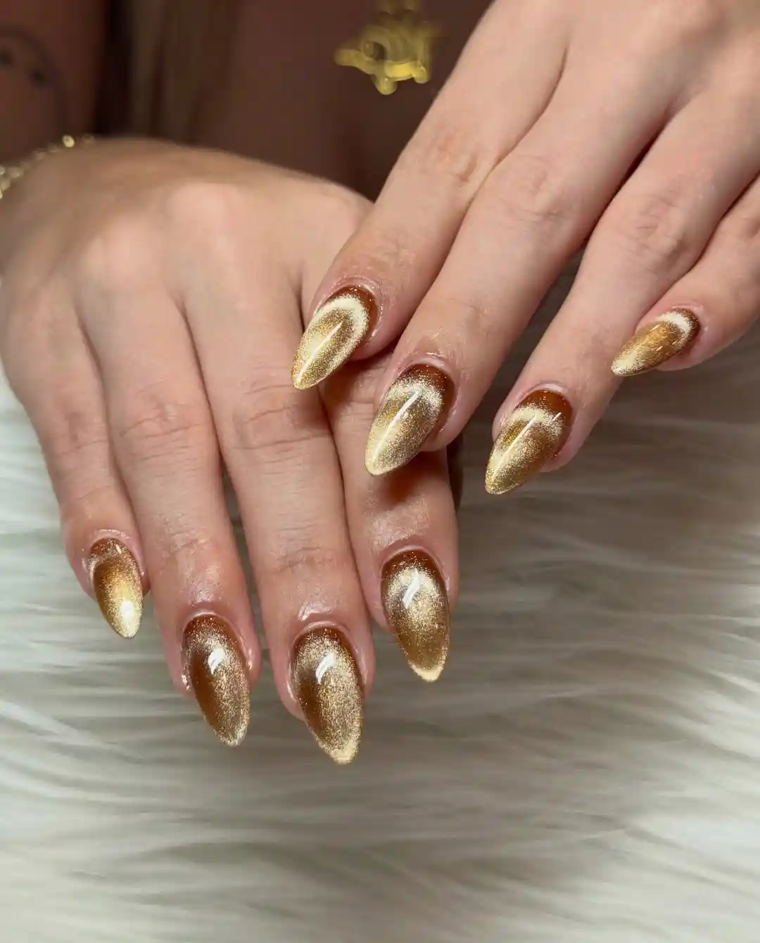 Glossy gold reflective almond nails