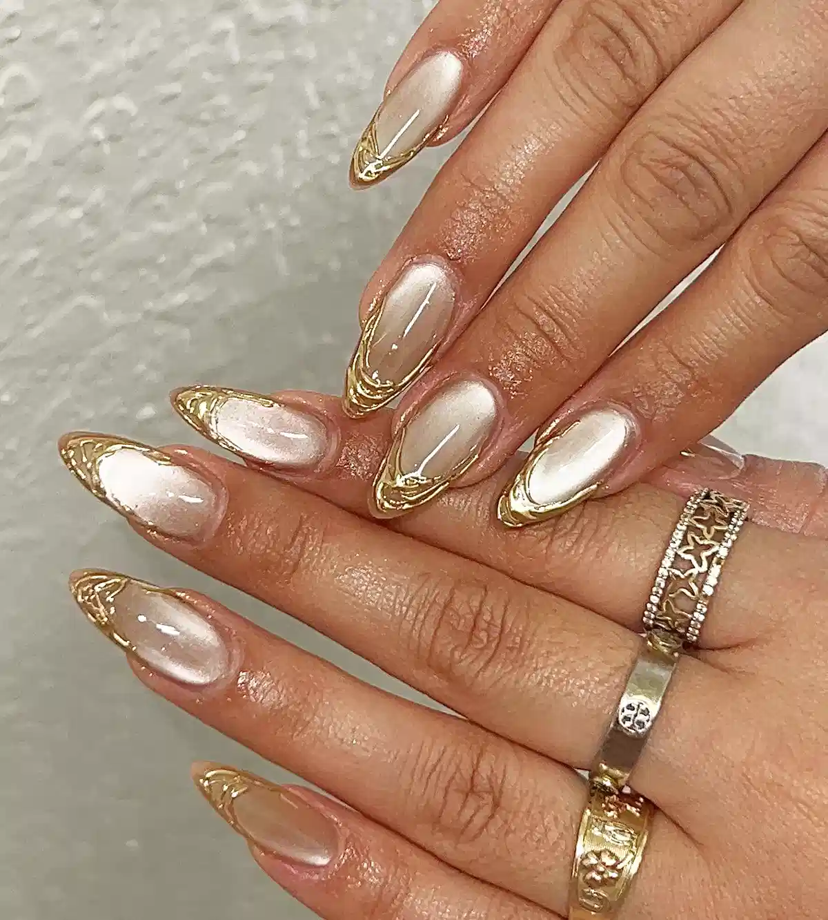 Pearly nude nails with gold metallic edging