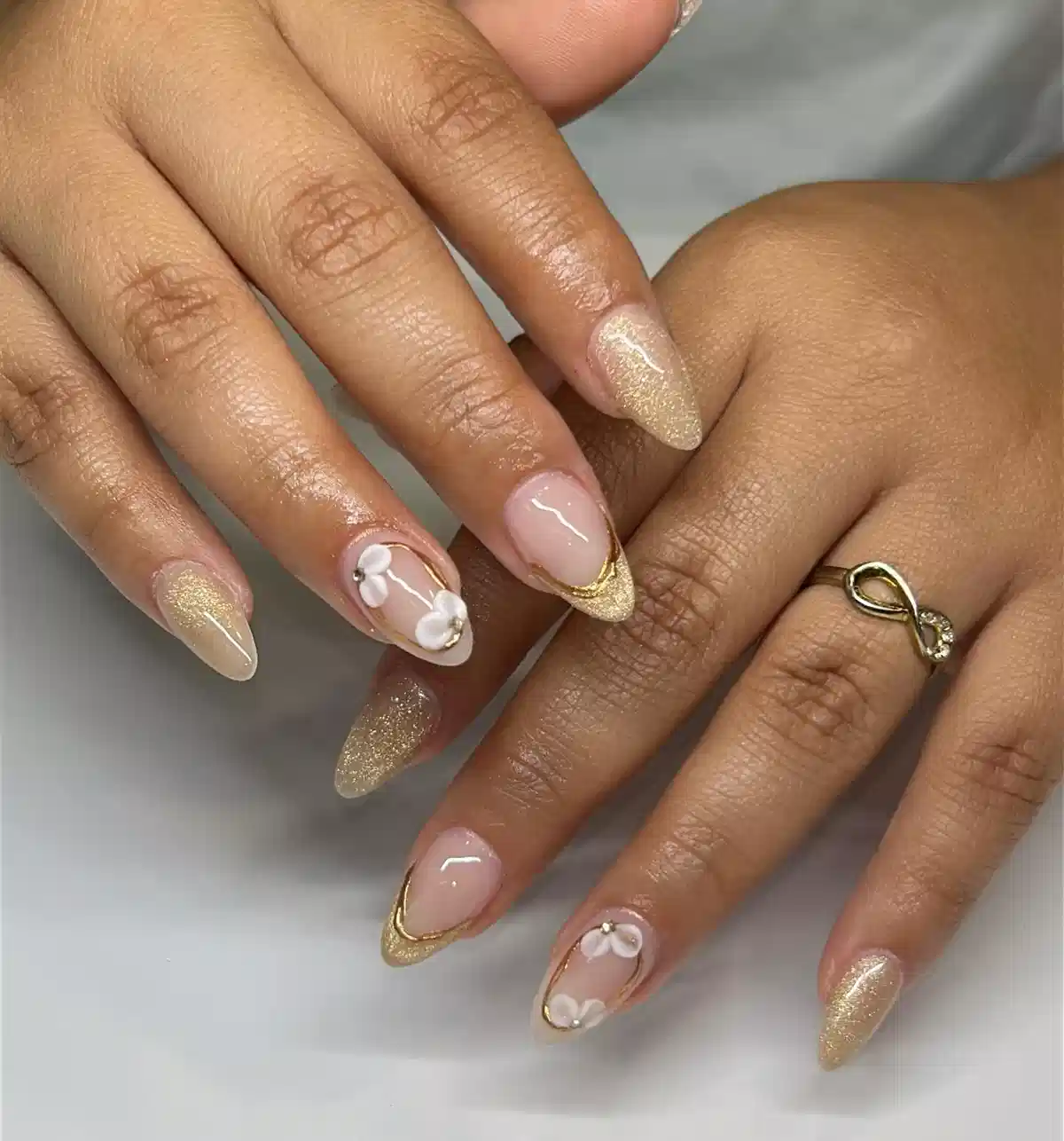 Nude pink and gold glitter tips with 3D white flowers