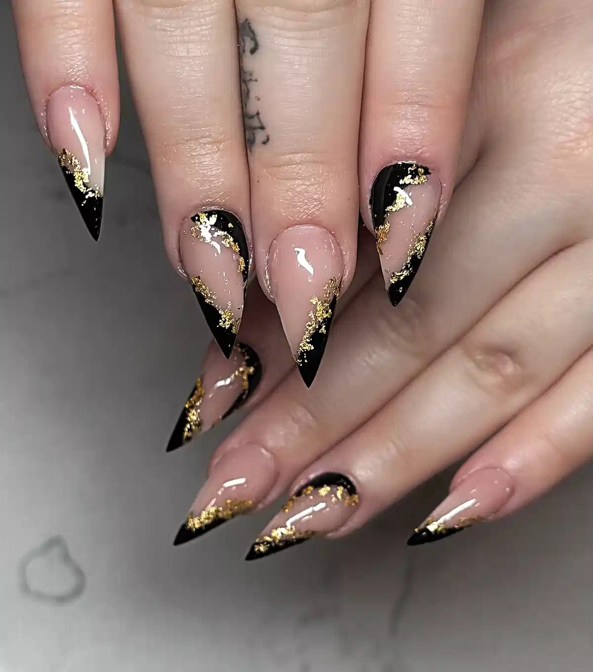 Stiletto nude-and-black tips edged with gold accents