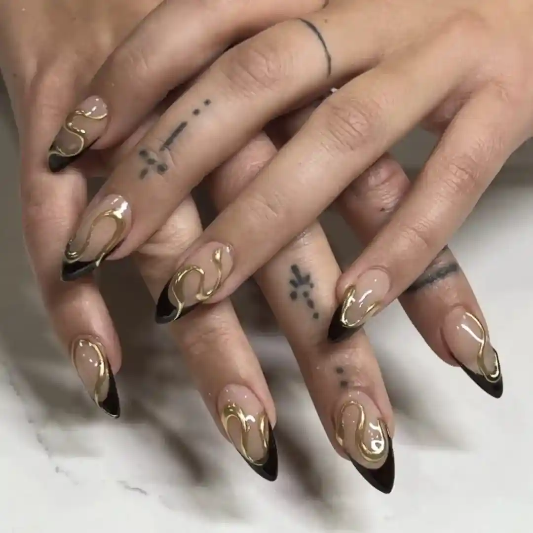 Black French tips with raised gold swirl accents
