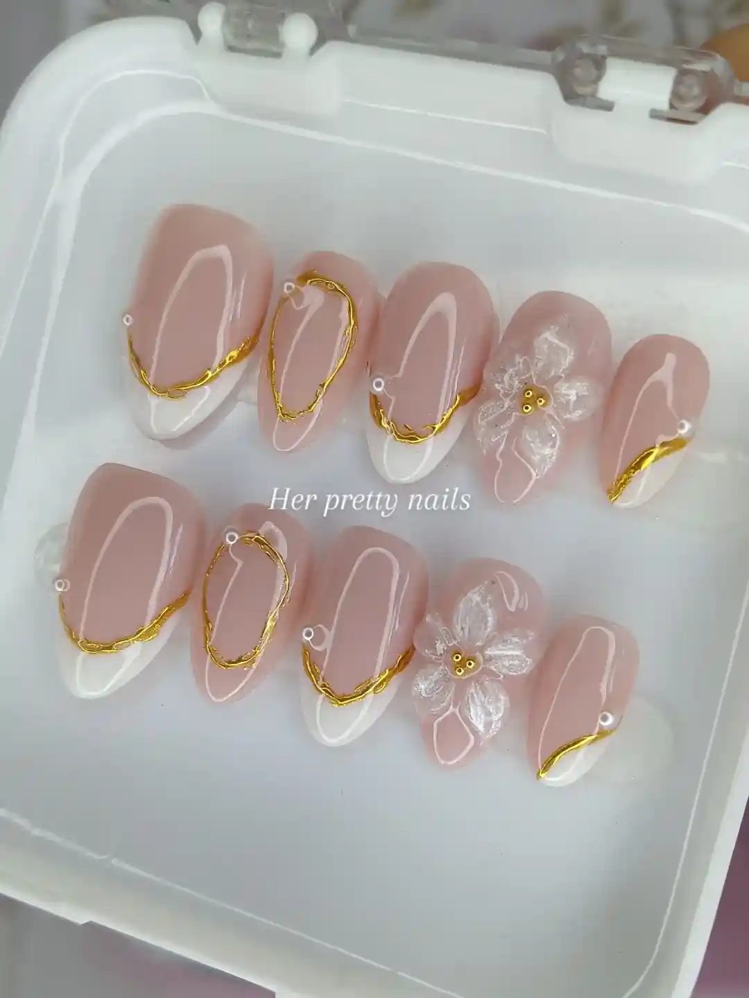 Nude-and-white French tips with gold outlines and 3D flowers