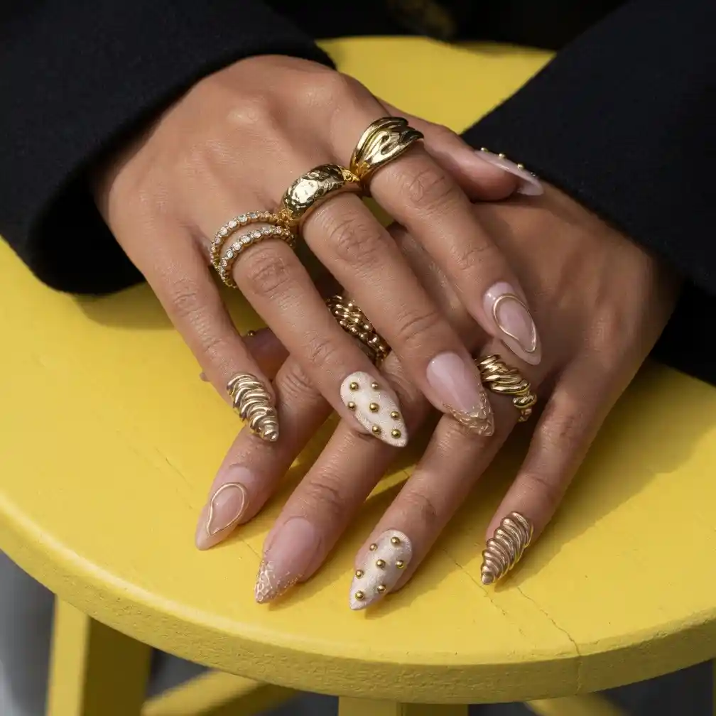 Mixed nude-and-gold set with studs and textured gold nails