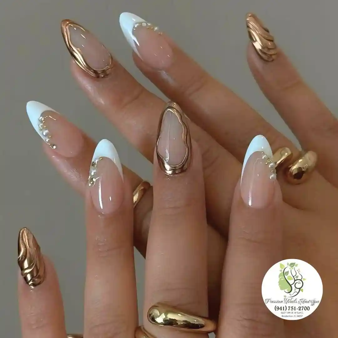 White French tips with raised gold framing and small rhinestone accents
