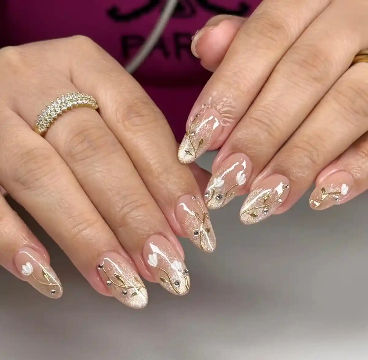 Gold shimmer tips with fine linework and studs
