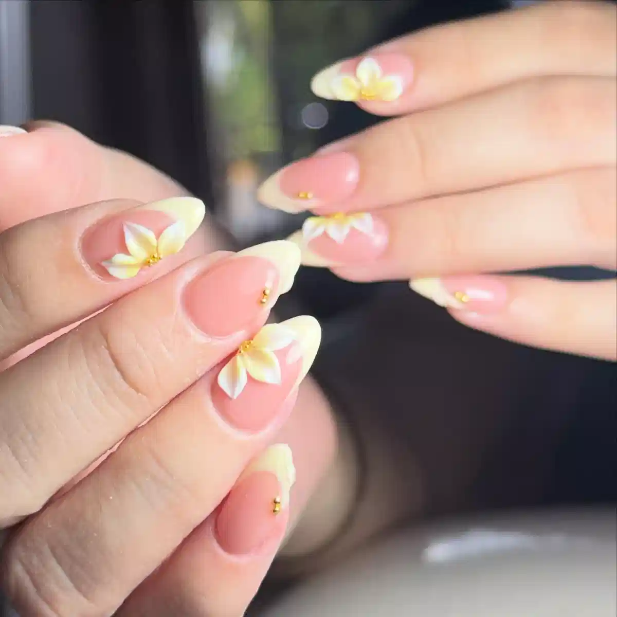 Pale yellow French tips with floral accents