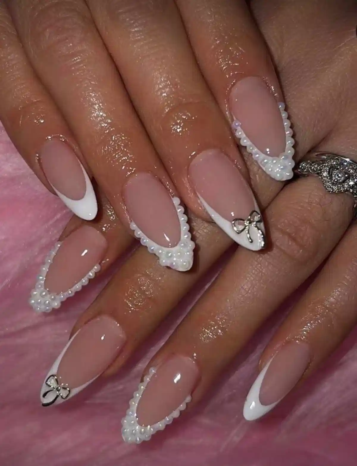 White French tips with beaded borders and bow charms