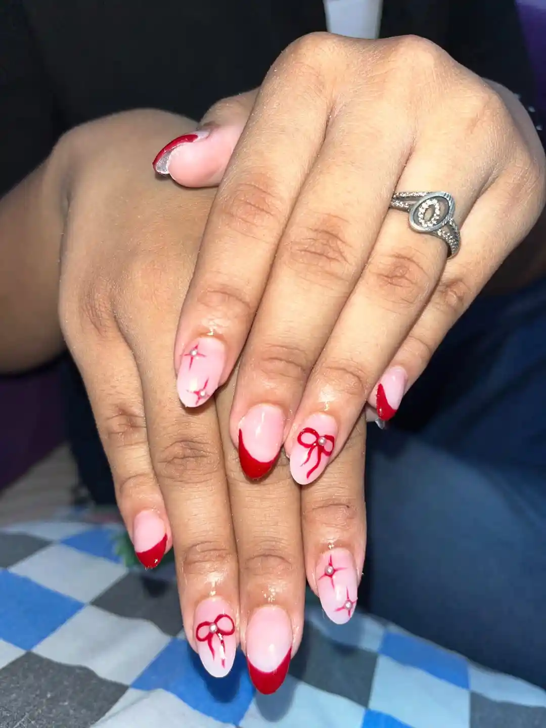 Red French tips with bow and rhinestone line details