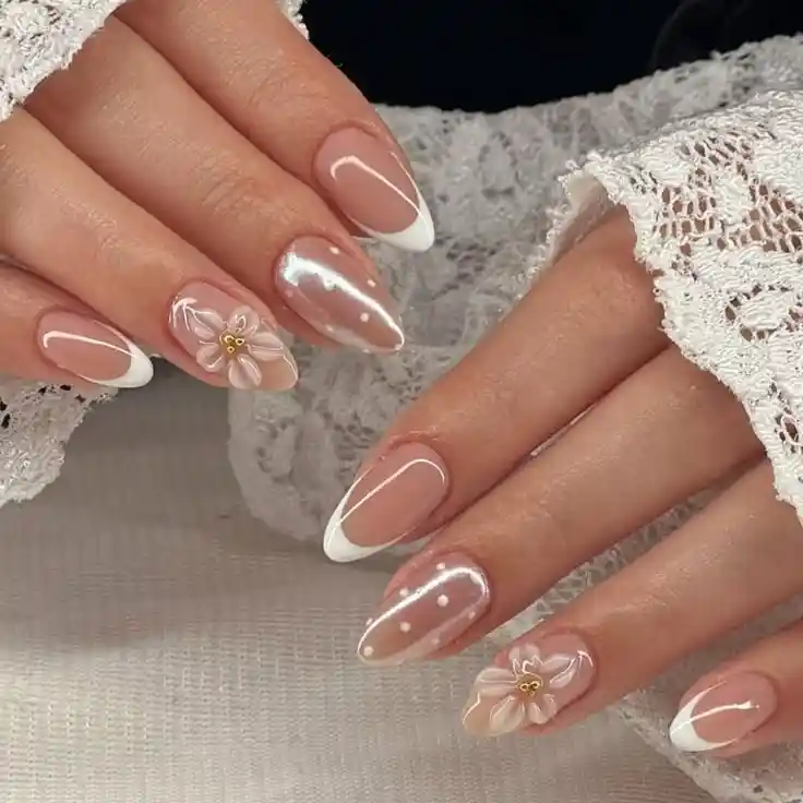 White French tips with lace-like dot accents and 3D flowers