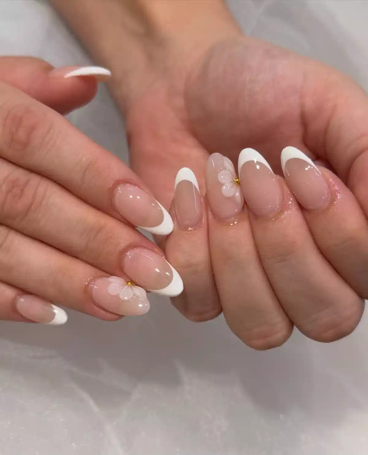 Classic white French tips with minimal 3D florals