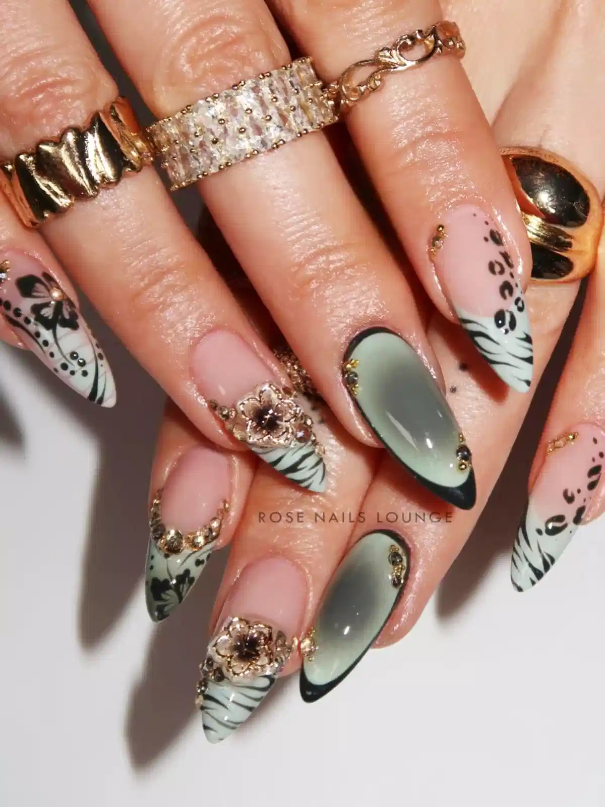 Green gradient stilettos with black tips and bold patterns