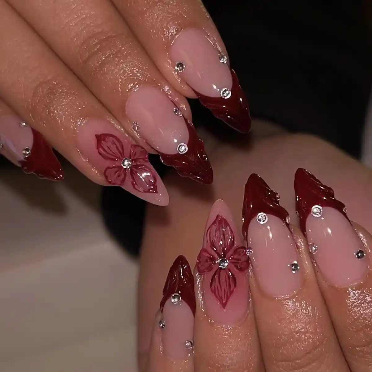 Burgundy French tips with rhinestones and floral art