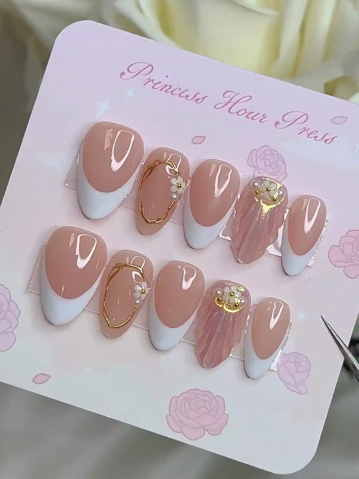 Press-on set on display card with white French tips and gold accents