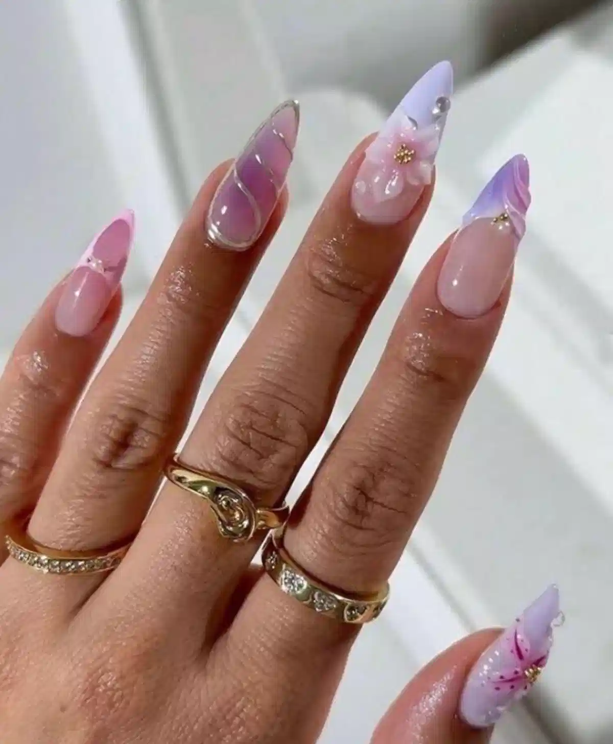 Pink–lavender ombre pointed nails with 3D floral accent