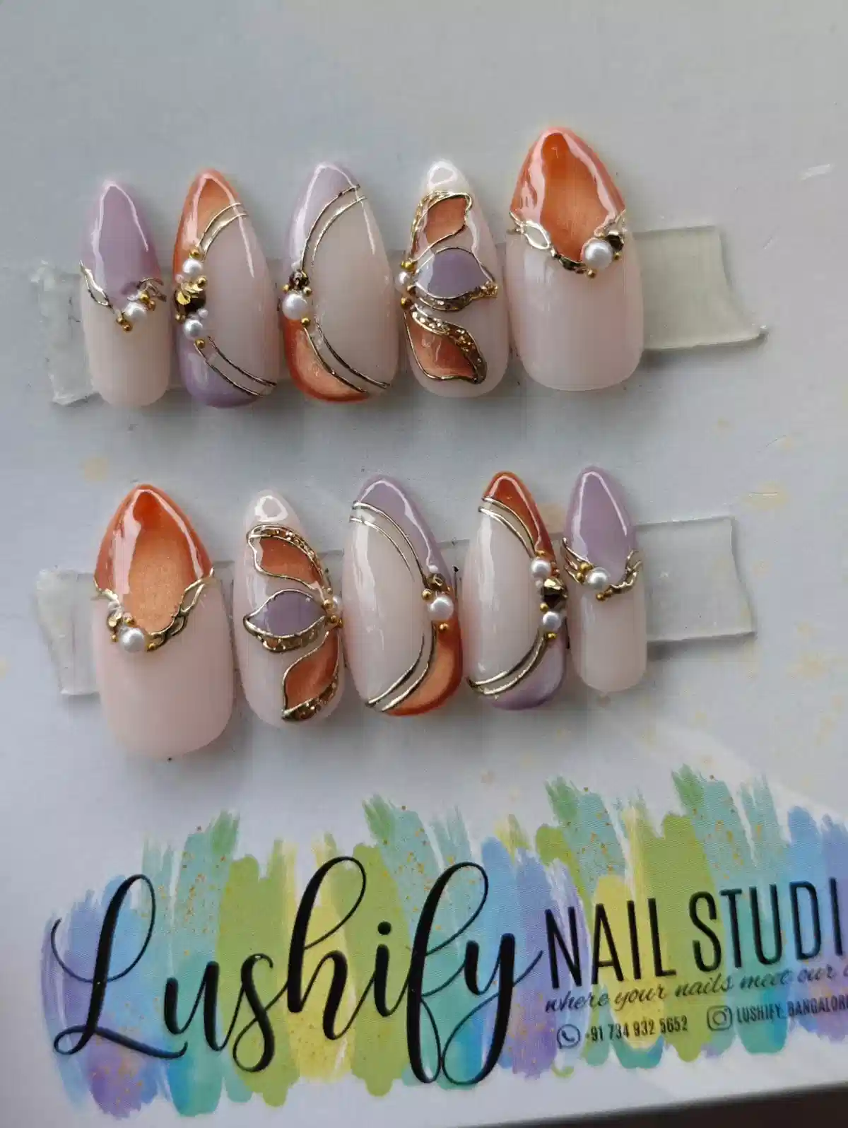 Nude–lavender set with gold lines and pearl accents
