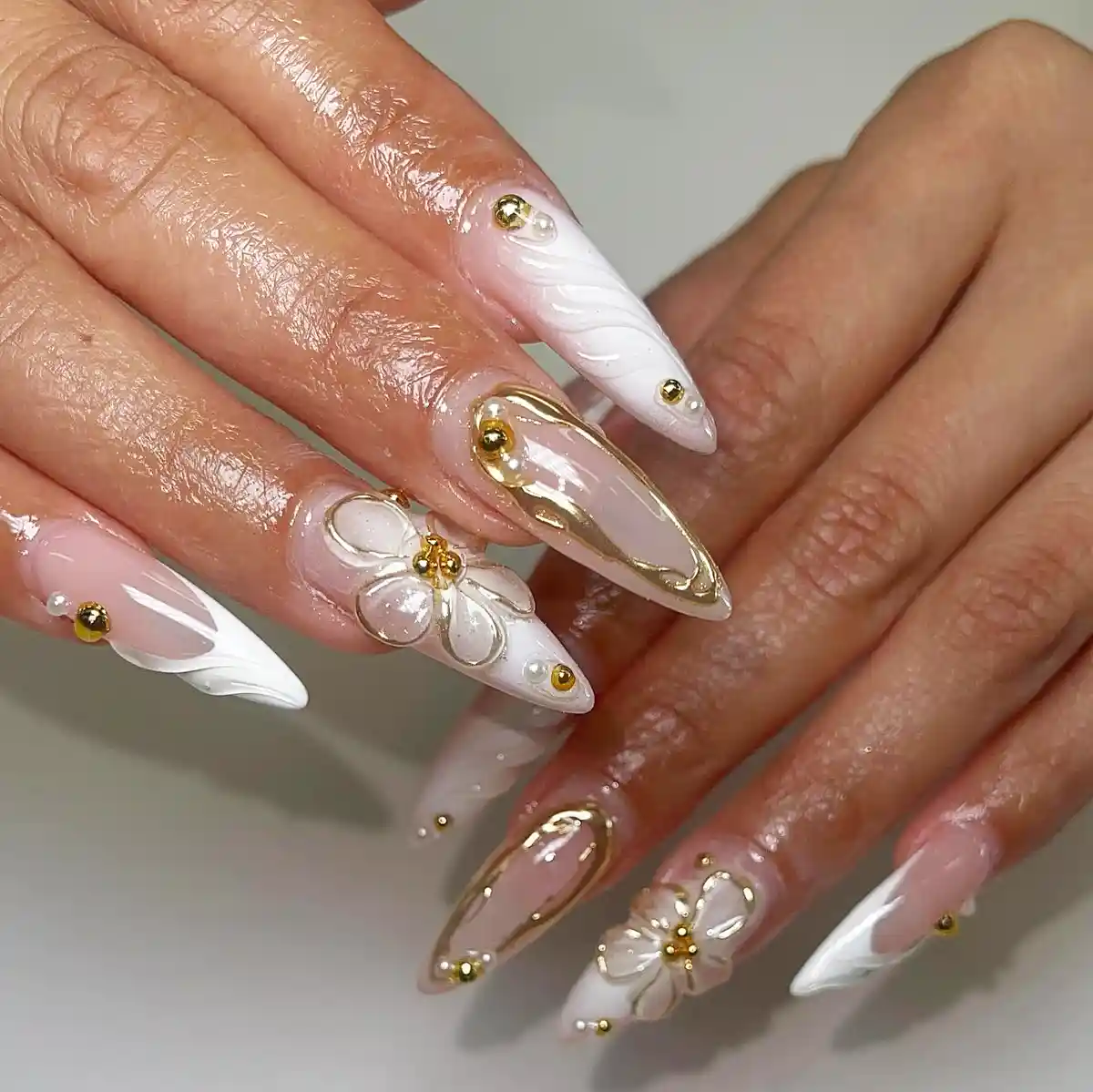 Pointed white swirls with gold studs and 3D flowers