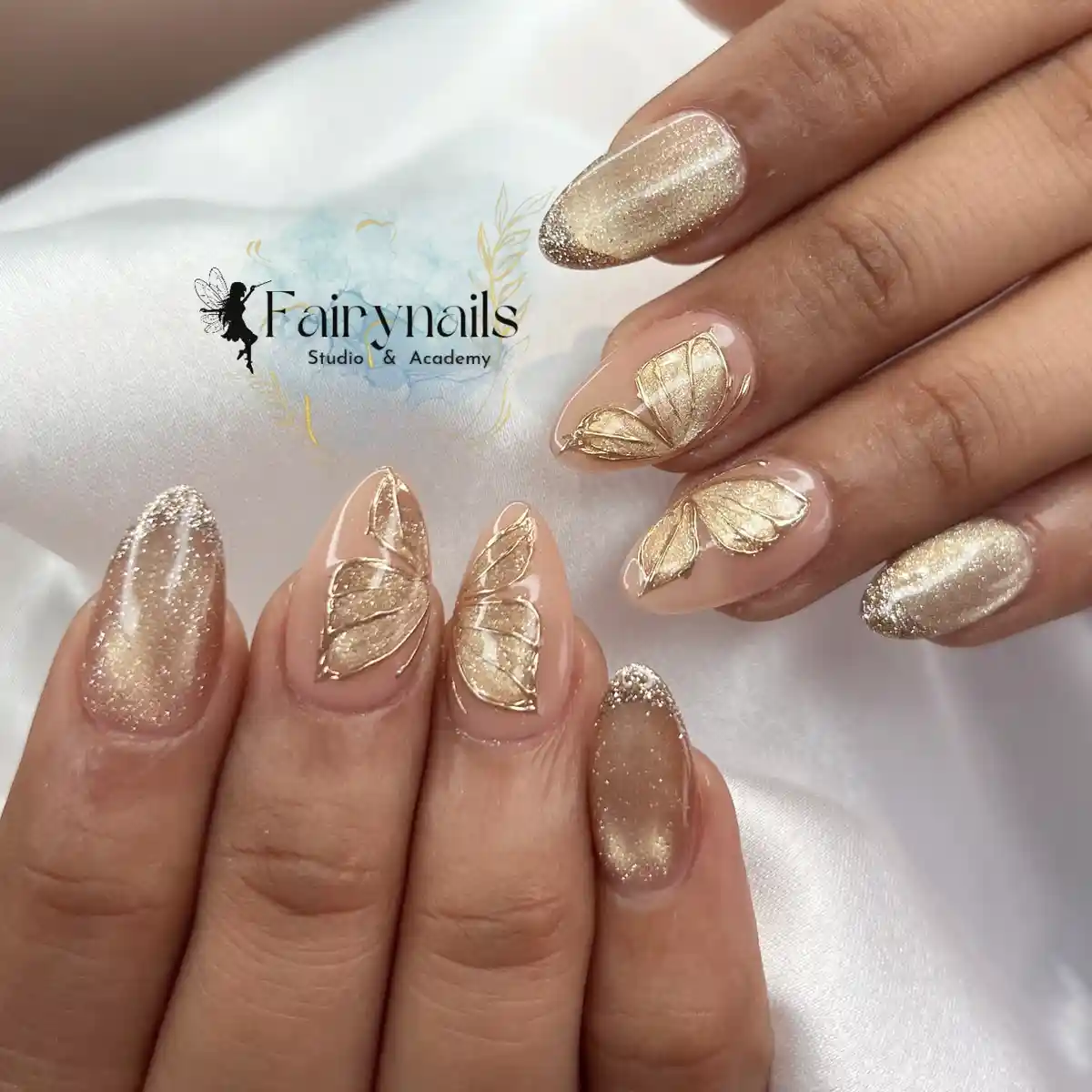 Gold glitter and gold leaf motifs on nude almond nails