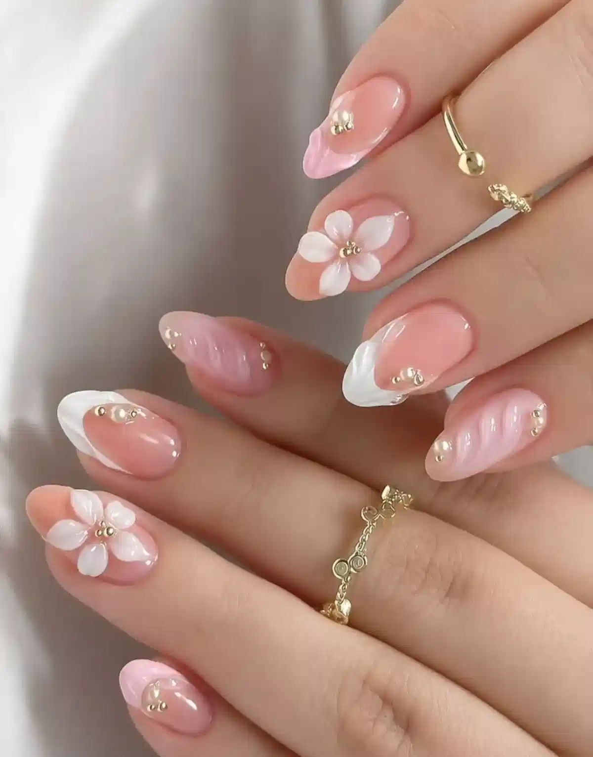 Soft pink and white French tips with 3D white flowers