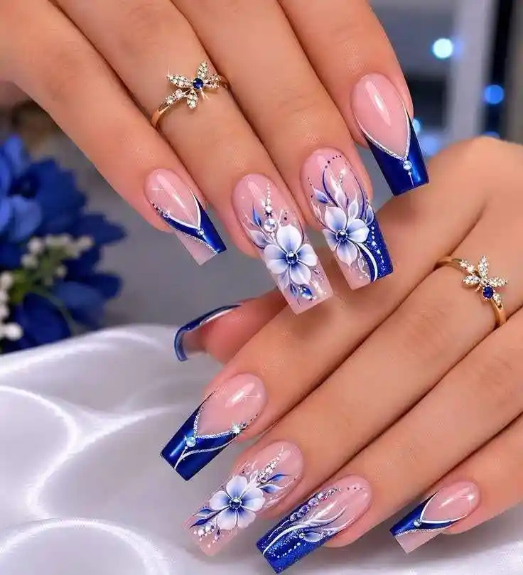 Blue French tips with floral accent nails on long square shape