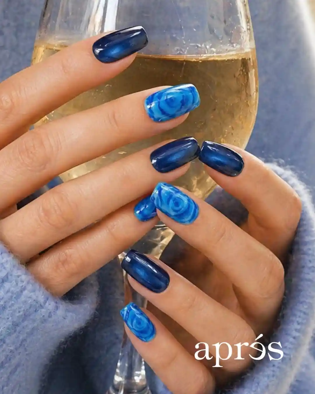 Navy glossy nails with bright blue rose-pattern accent nails