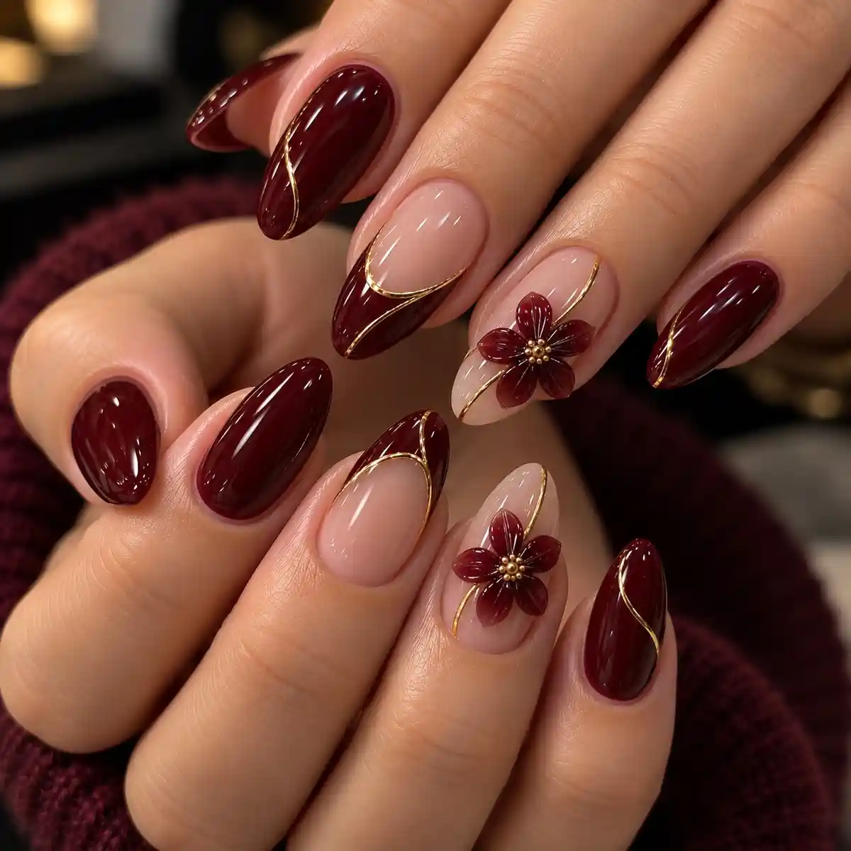 Deep burgundy-brown and nude nails with gold curves and 3D flowers