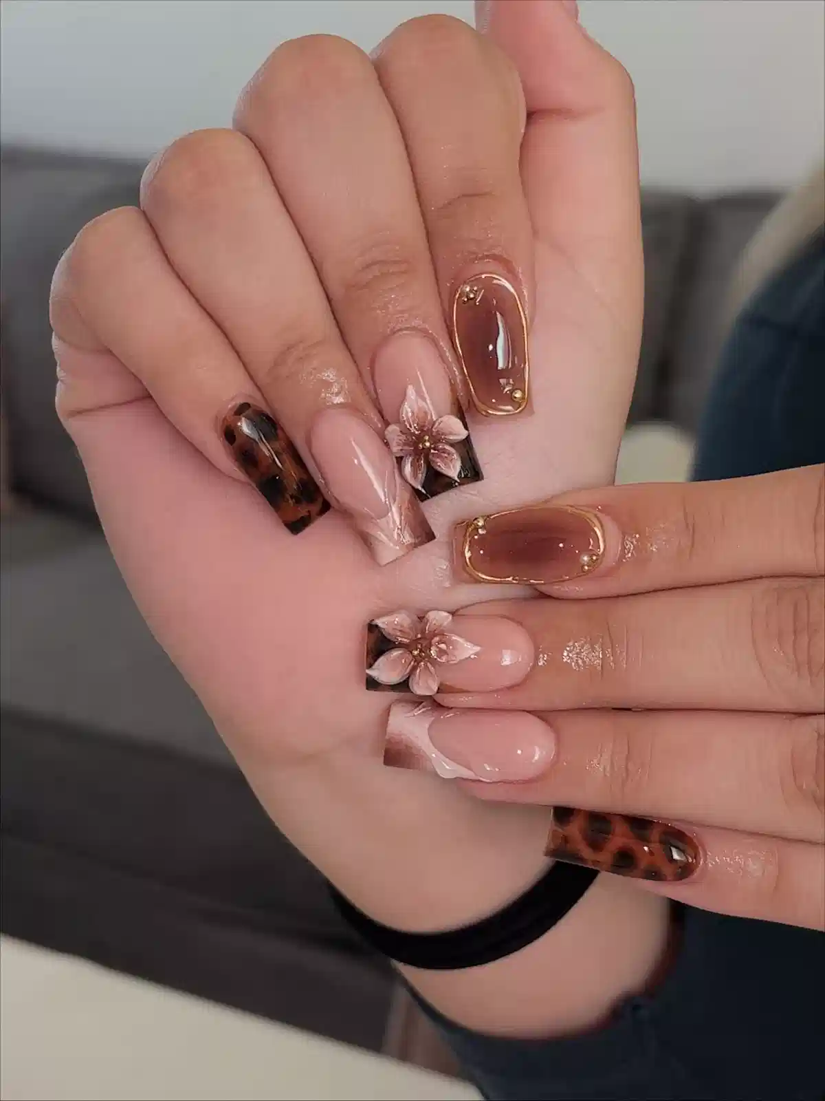 Square brown set with animal-spot accents, gold framing, and raised flowers