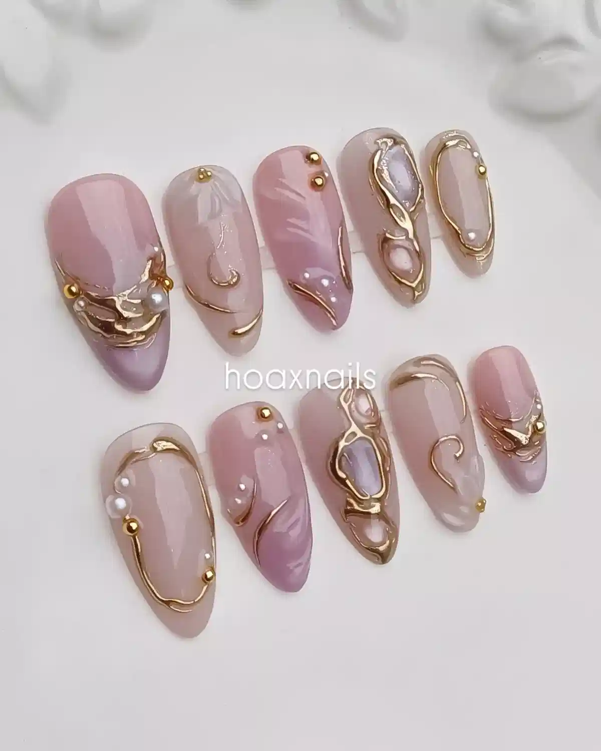Pale pink and lavender set with raised gold-toned framing and studs