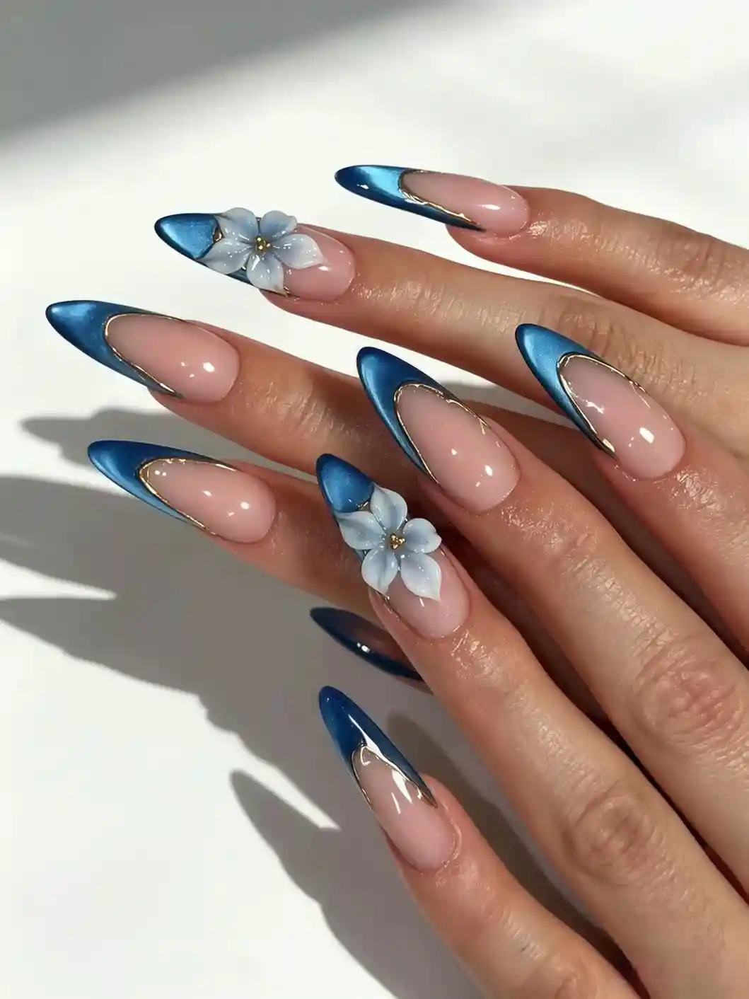 Metallic blue French tips with 3D flowers