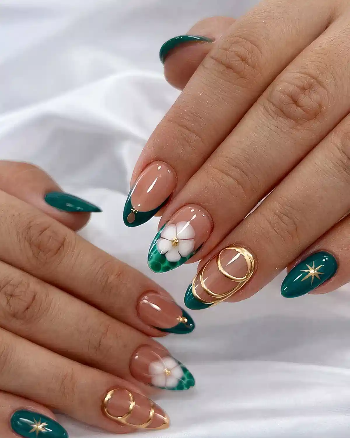 Teal French tips with raised white flowers and gold accents