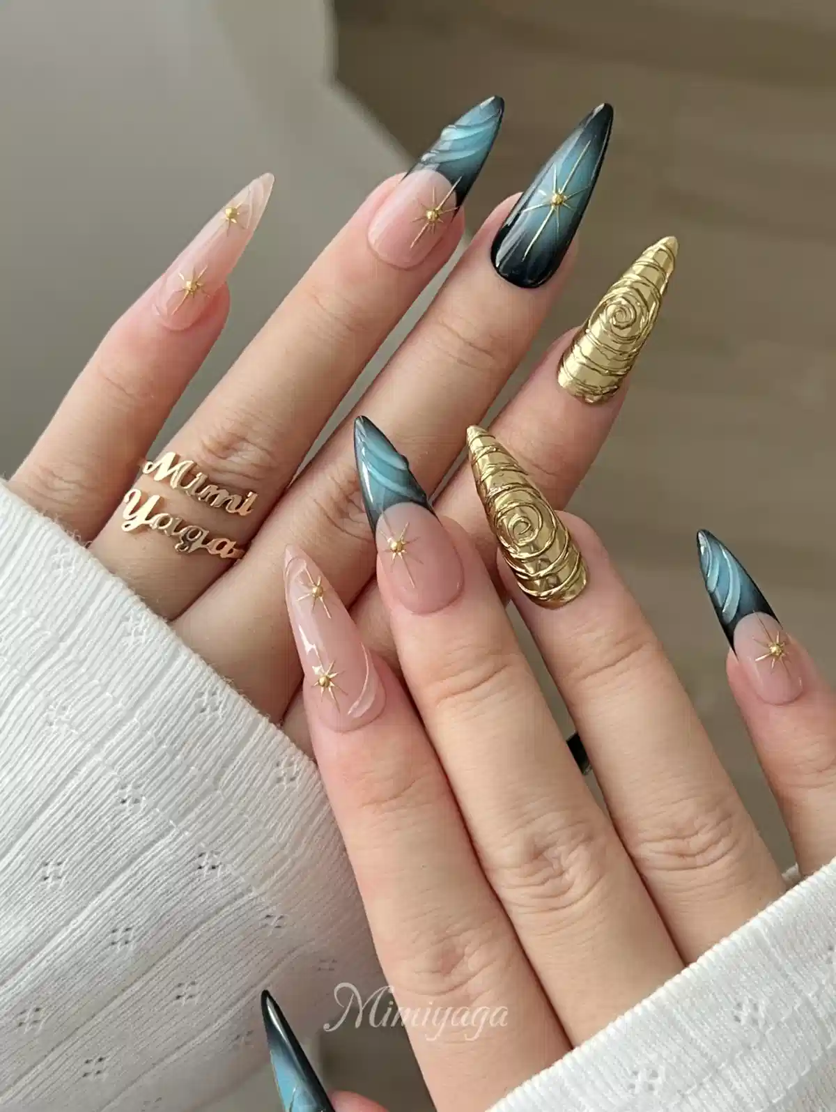 Gradient tips with gold starbursts and raised gold statement nails