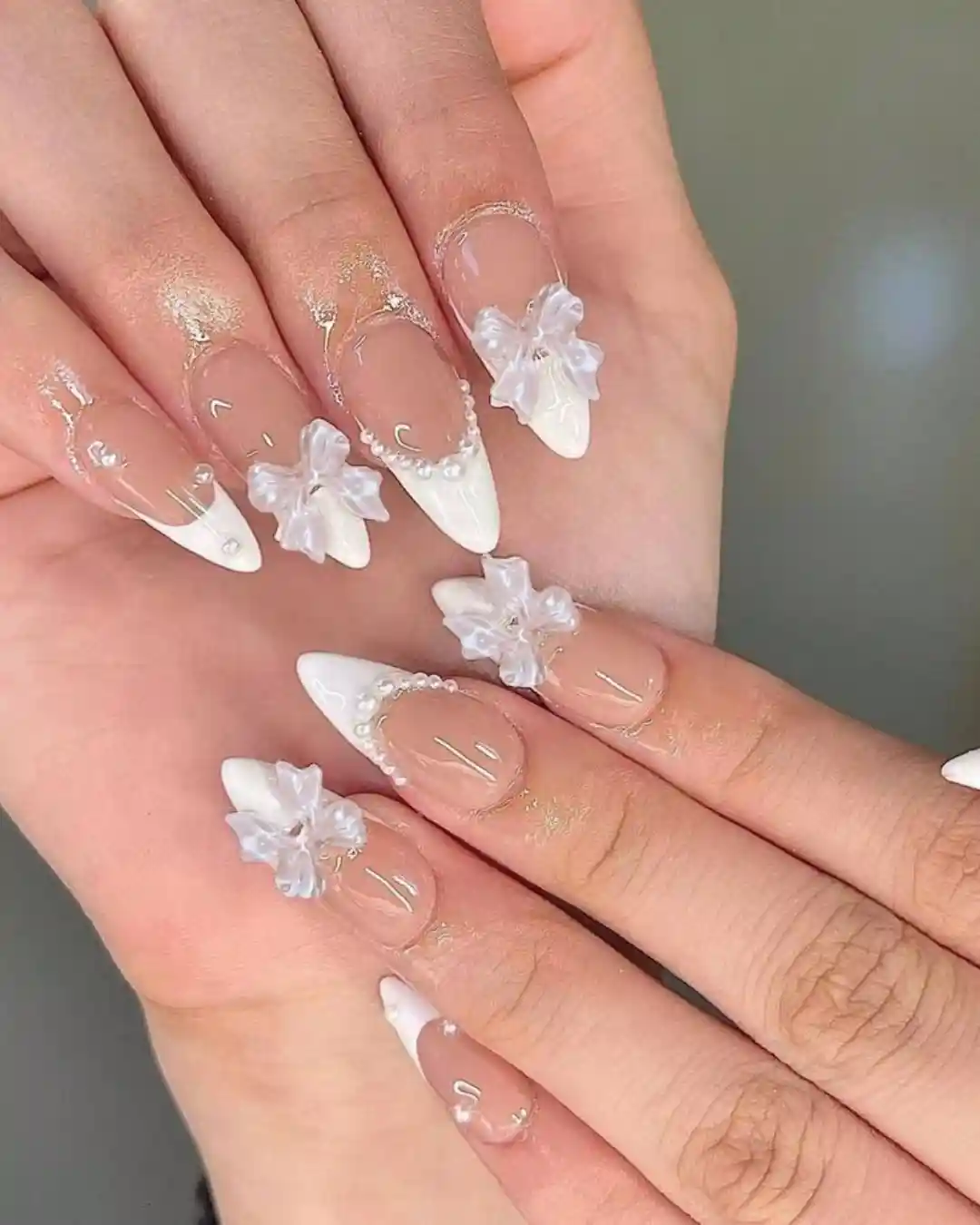 White French tips with 3D bows and pearl-like accents