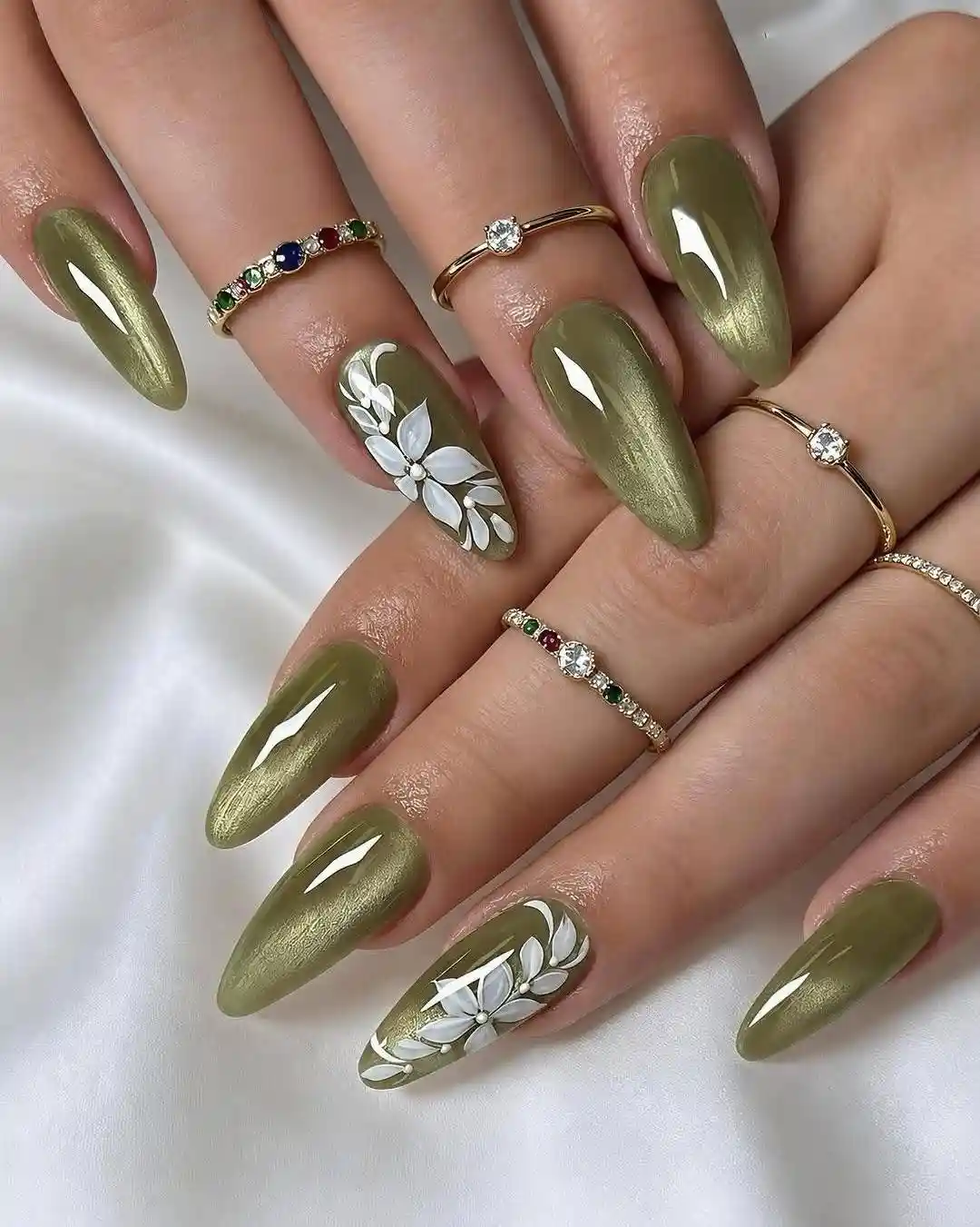 Metallic olive nails with white floral accents