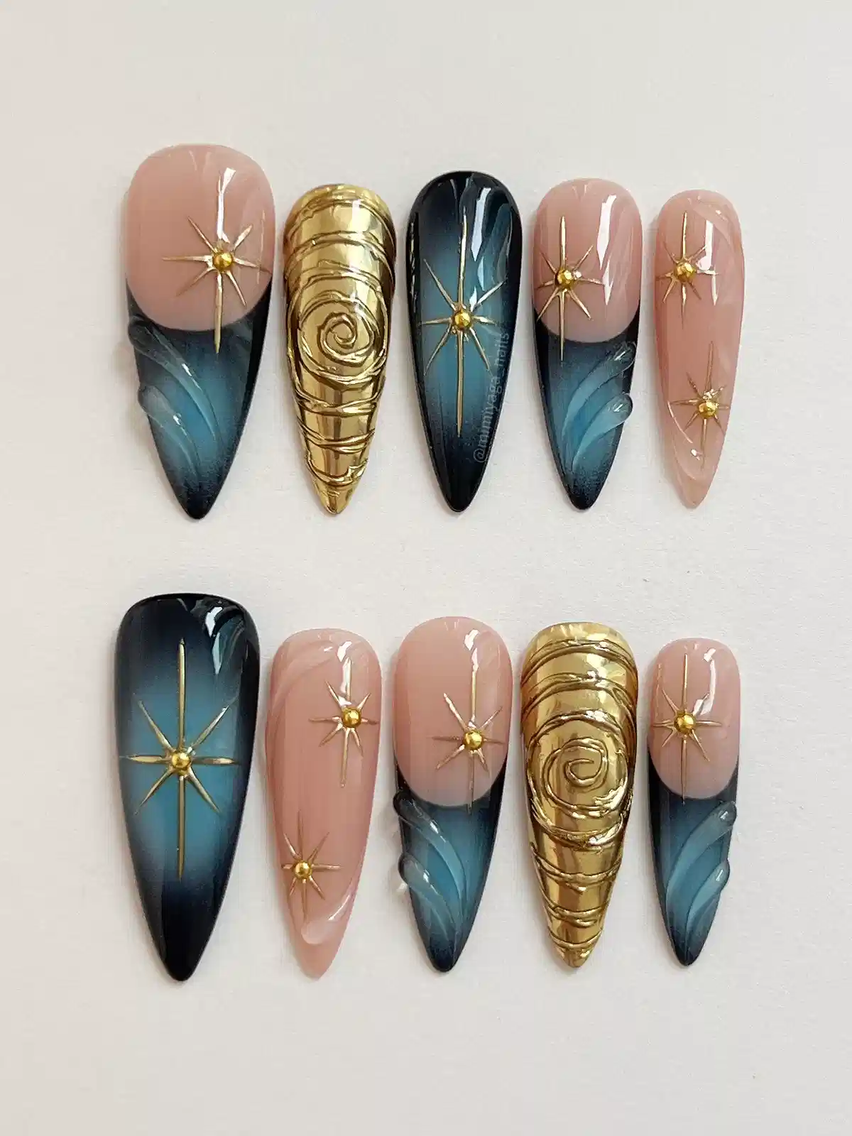 Starburst accents with teal-black gradients and sculpted gold nails
