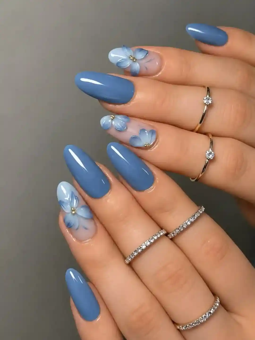 Solid blue nails with soft blue floral accent nails