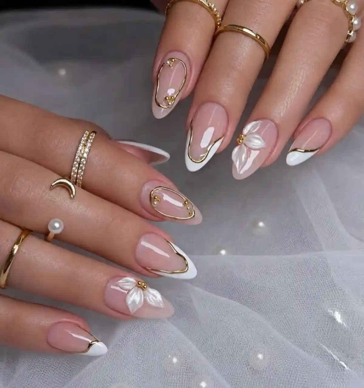 White French tips with gold outlines and 3D flower accents