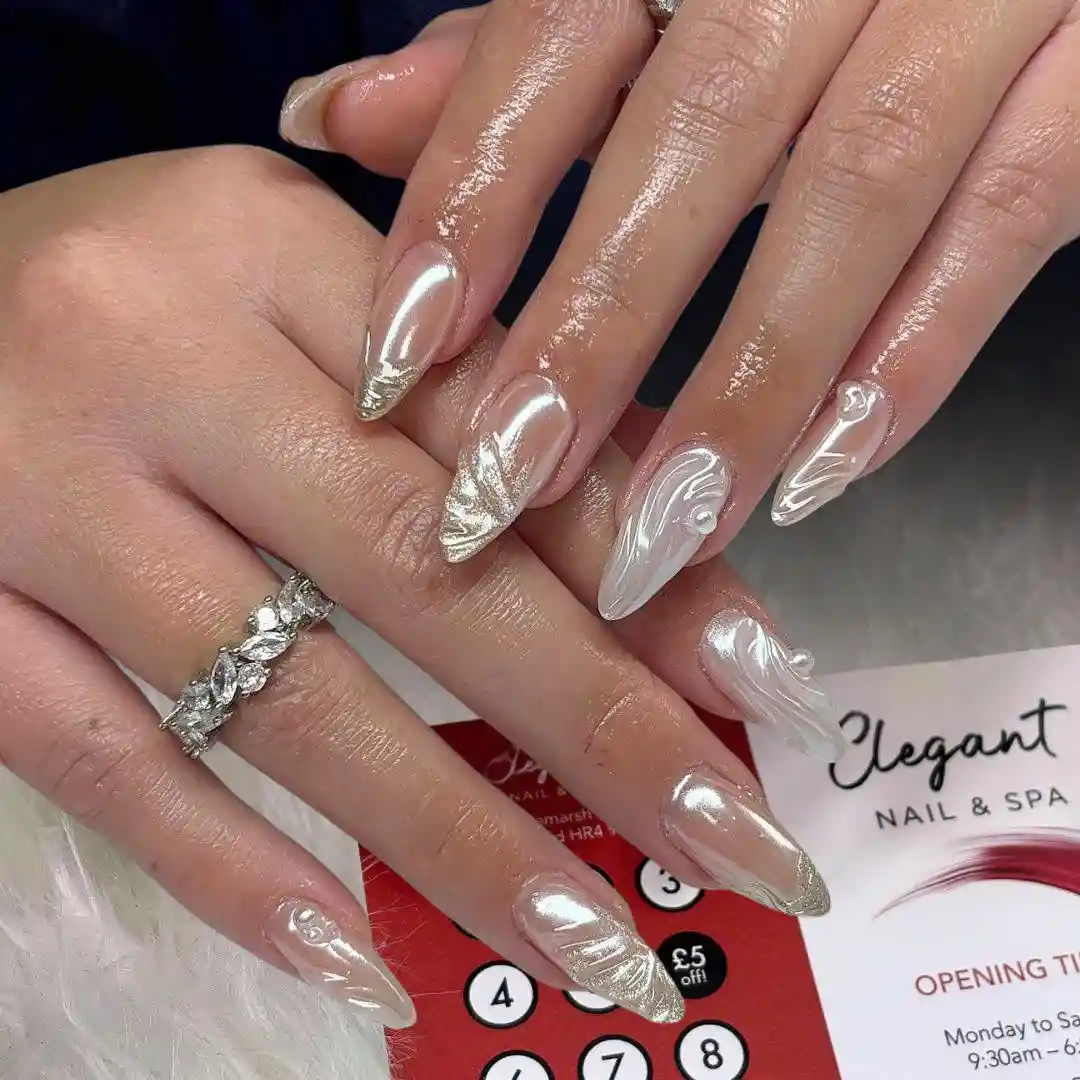 Metallic silver-toned nails with raised white swirls