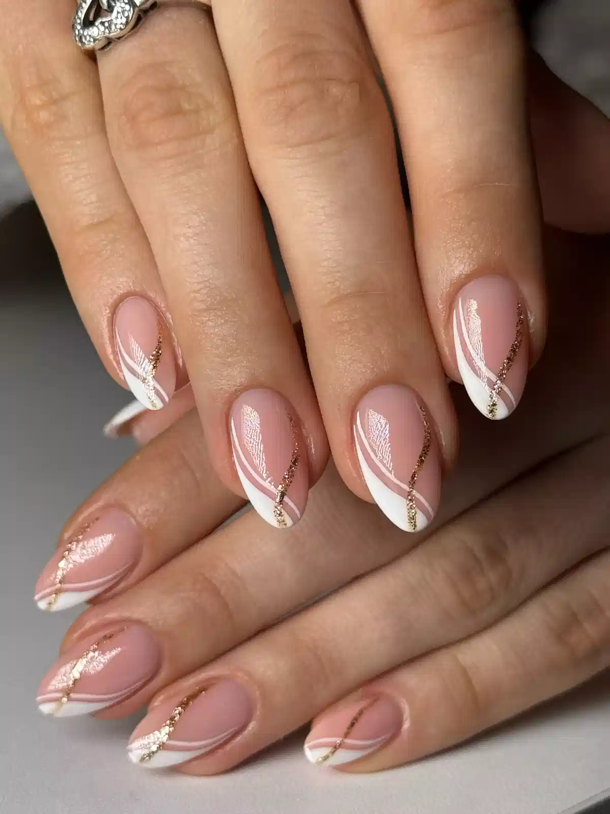 Diagonal white French tips with gold glitter striping
