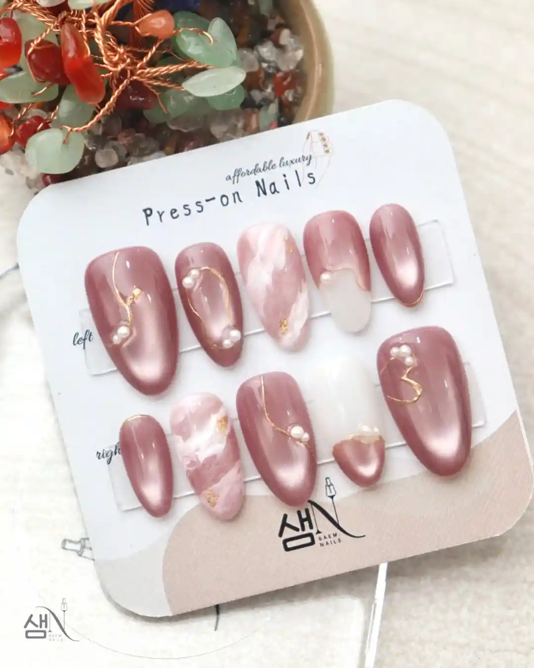 Mauve pearly set with marbled accents, pearls, and a heart-shaped nail