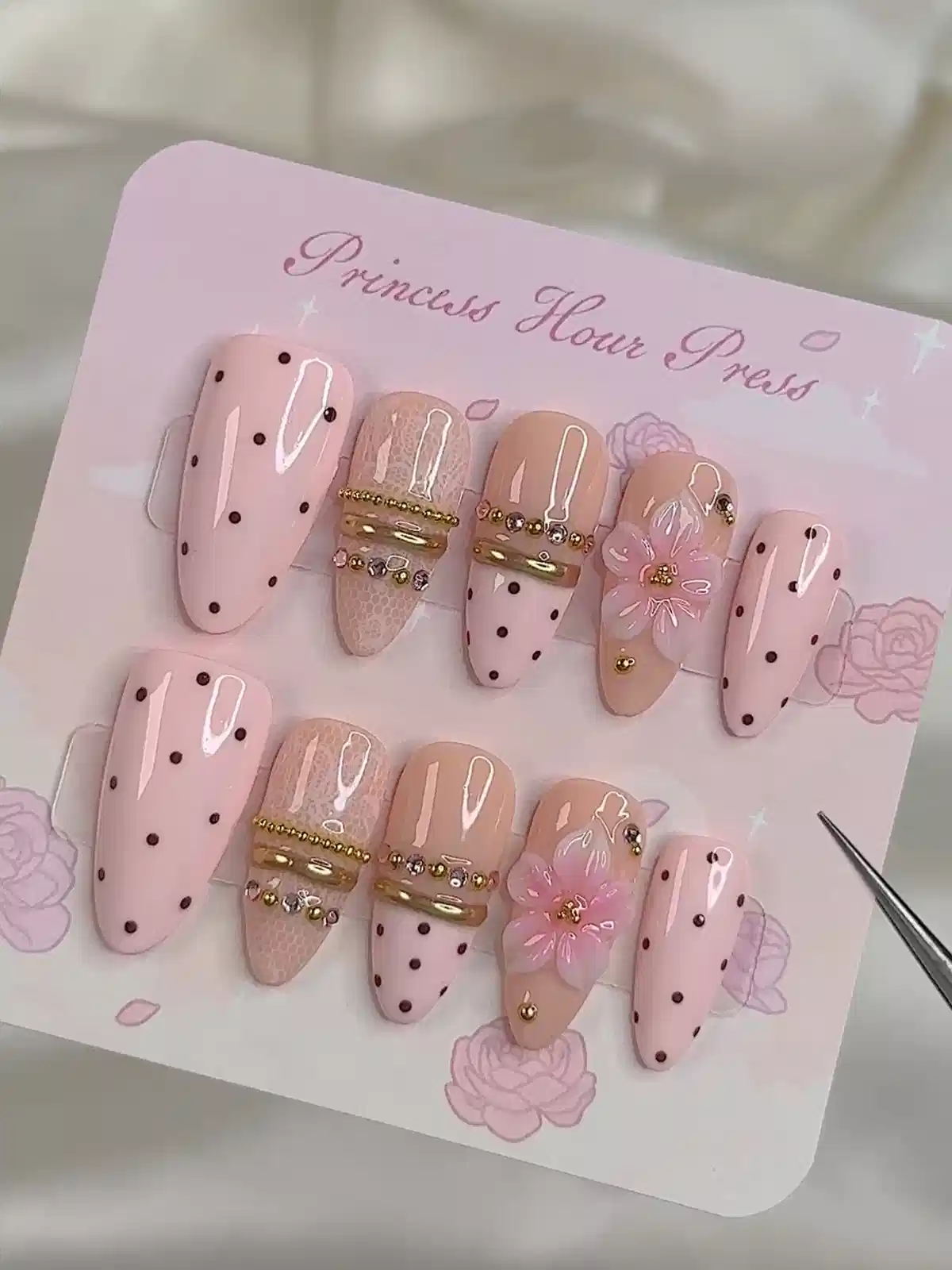 Pink polka-dot set with gold band accents and raised flower detail