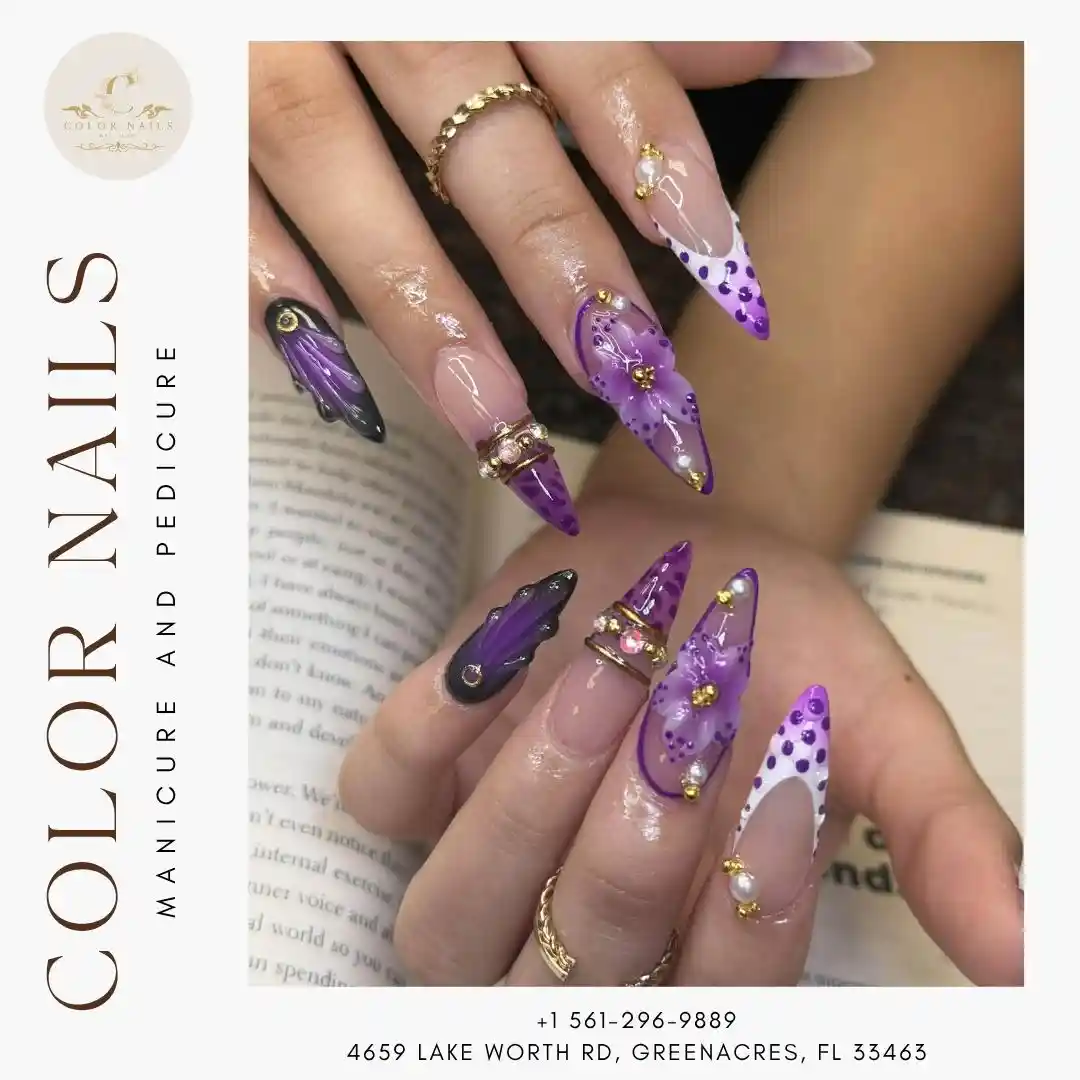 Purple stiletto nails with dots, marbling, and gold/pearl embellishments
