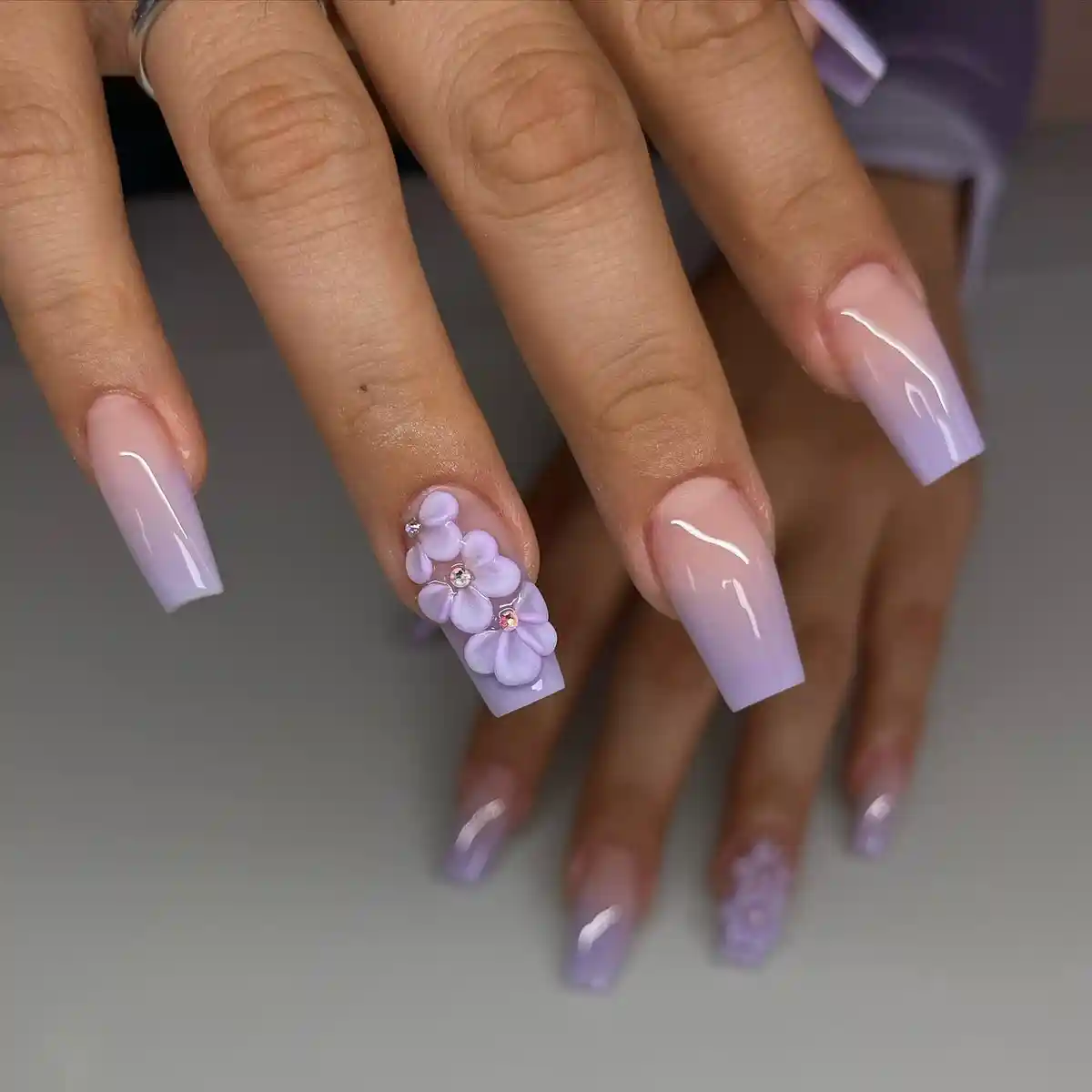 Soft lavender ombre coffin nails with 3D flower cluster accent