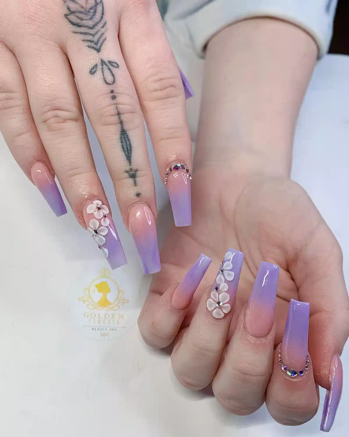Lavender ombre coffin nails with white 3D flowers and rhinestones
