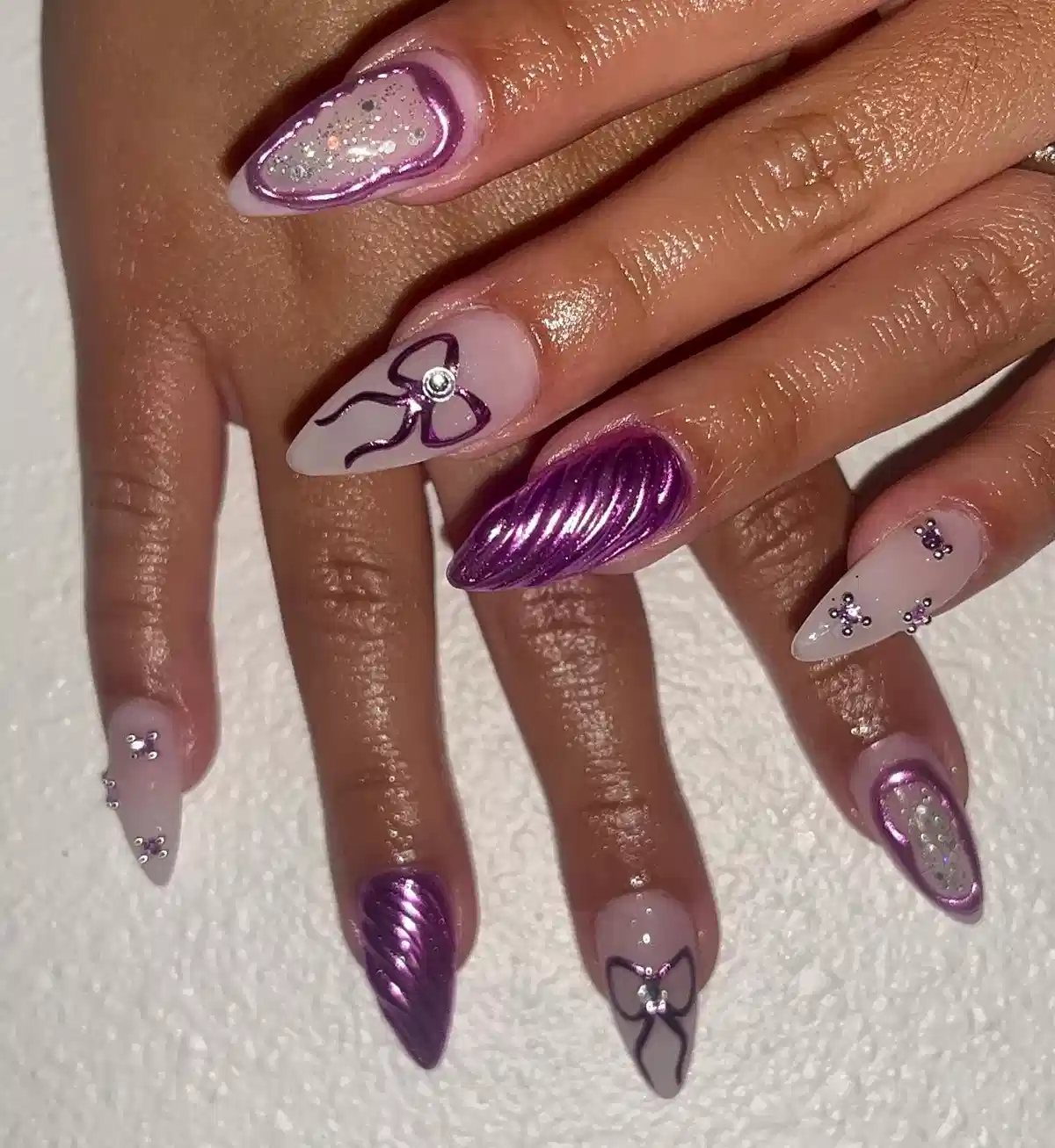 Metallic purple ridges with bows and rhinestone clusters