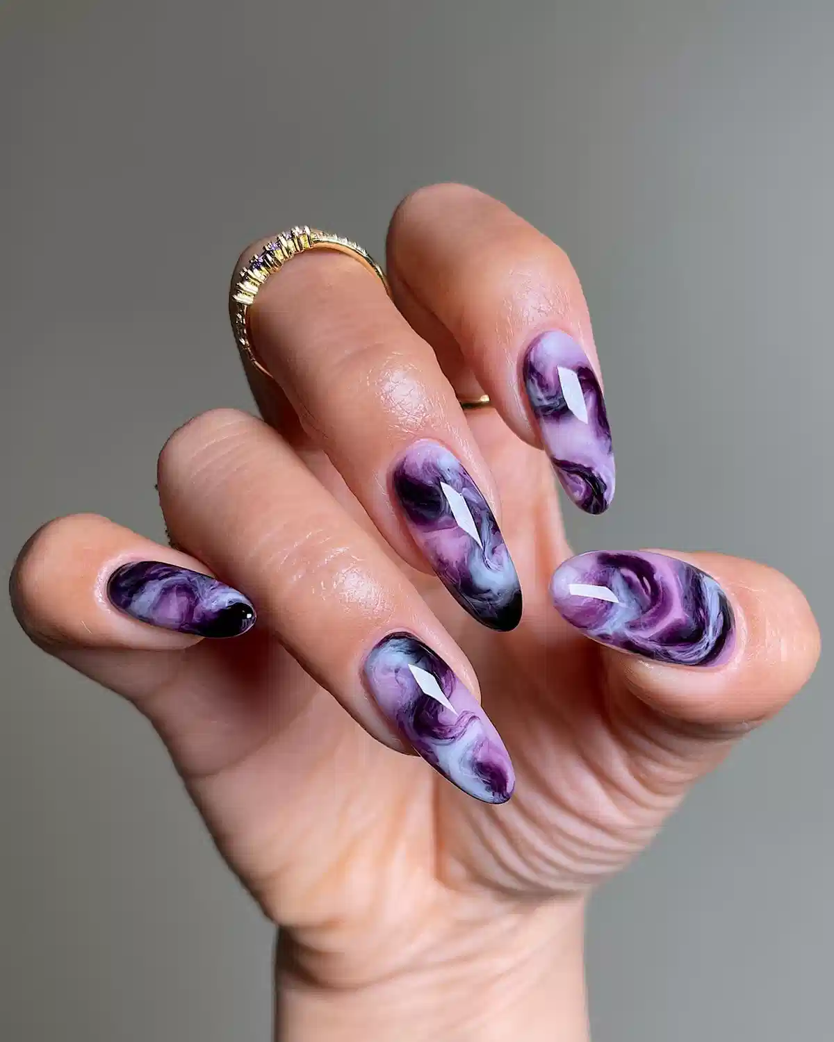 Purple marble swirl nails with black and white accents