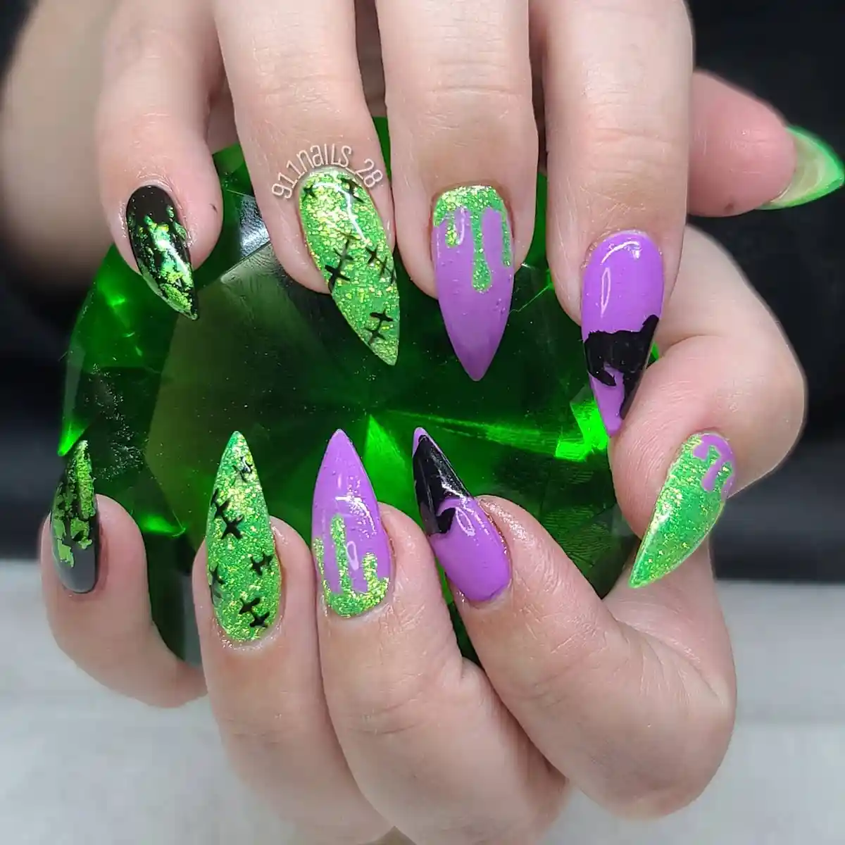 Purple and green glitter stilettos with drips and black X details
