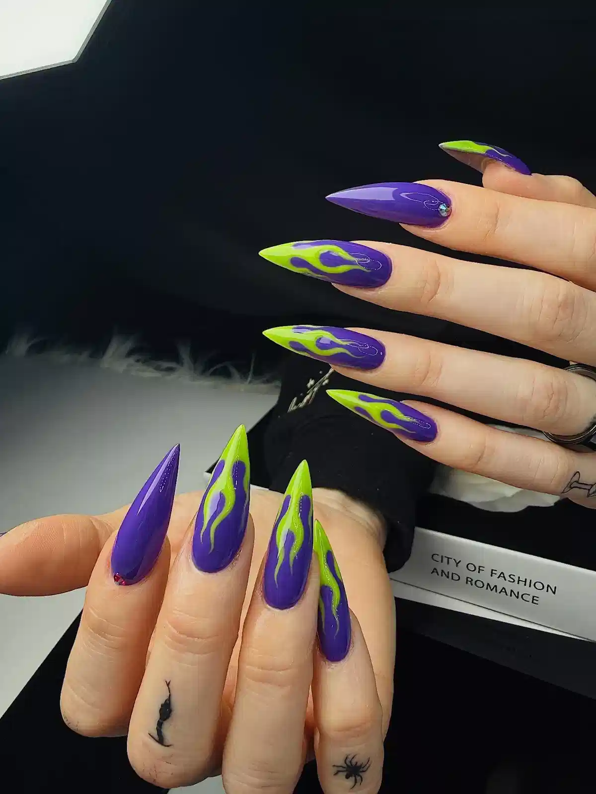 Extra-long purple stilettos with neon green flame motifs