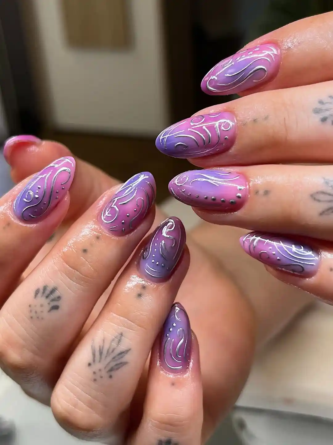 Pink-purple gradient with white swirls and dotted accents