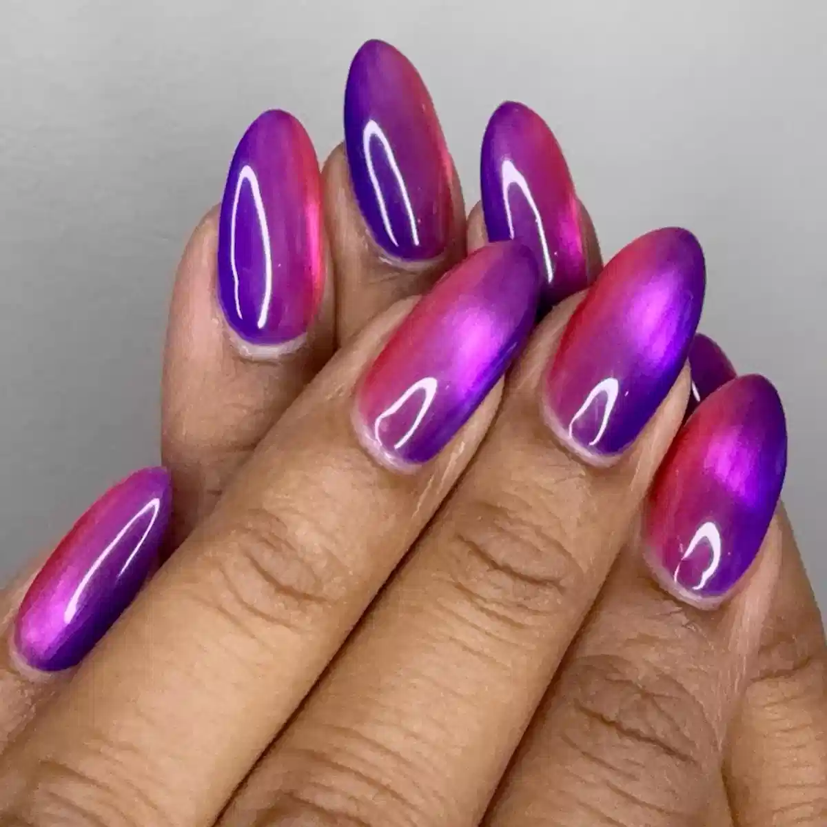Glossy purple-to-magenta gradient chrome nails